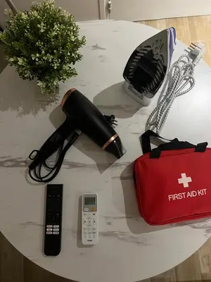 a table topped with a first aid kit and a phone at Appartement confort au cœur de Nice in Nice