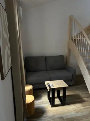 a living room with a couch and a table at Appartement confort au cœur de Nice in Nice