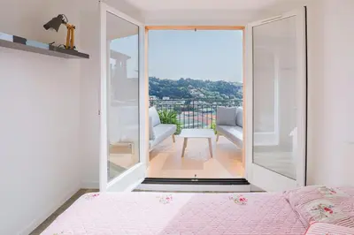 a bedroom with a view of a balcony at Villa Bleu Azur - Élégance Privée avec Vue Mer & Montagne in Cagnes-sur-Mer