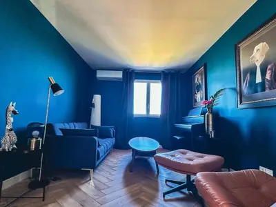 a blue living room with a couch and a table at Villa Bleu Azur - Élégance Privée avec Vue Mer & Montagne in Cagnes-sur-Mer