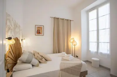 a white bedroom with a bed and a window at #56 2P Massena Central close promenade,Old Town, AC in Nice