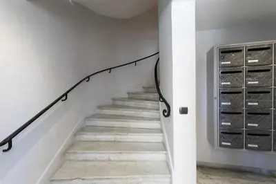 a staircase with a black handrail and white walls at #56 2P Massena Central close promenade,Old Town, AC in Nice