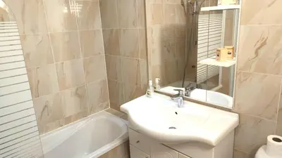 a bathroom with a sink and a mirror and a tub at Superbe appartement carre d or in Nice