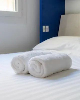 two towels sitting on top of a bed at 2 pièces - Clim - tram à 5' centre à 15' in Nice