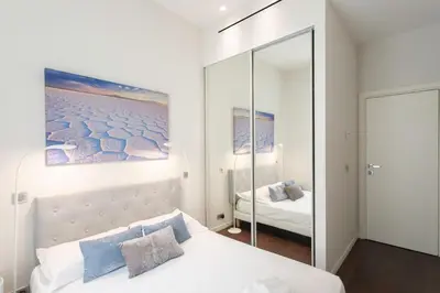 a bedroom with a white bed and a mirror at #60 Grimaldi 2BDR central near beach,promenade AC&WIFI in Nice