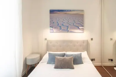 a bedroom with a bed and a painting on the wall at #60 Grimaldi 2BDR central near beach,promenade AC&WIFI in Nice