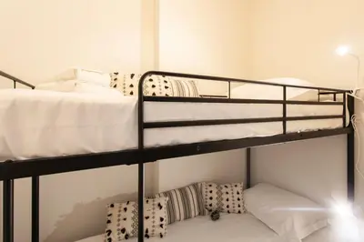 a bedroom with two bunk beds with white pillows at #60 Grimaldi 2BDR central near beach,promenade AC&WIFI in Nice