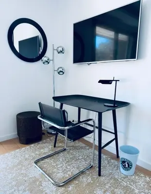 a black desk with a chair and a mirror at Contemporary Villa with Sea View, Infinity Swimming pool, Gym , Cinema room,Lift in Nice