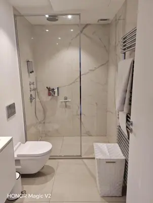 a bathroom with a shower and a toilet at Contemporary Villa with Sea View, Infinity Swimming pool, Gym , Cinema room,Lift in Nice