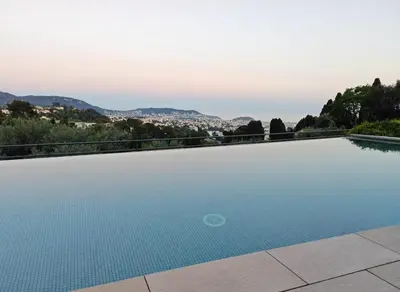 a swimming pool with a view of a city at Contemporary Villa with Sea View, Infinity Swimming pool, Gym , Cinema room,Lift in Nice