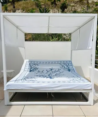 a white canopy bed sitting on a patio at Contemporary Villa with Sea View, Infinity Swimming pool, Gym , Cinema room,Lift in Nice