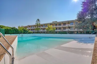 a swimming pool in front of a building at Il Cielo in Nice