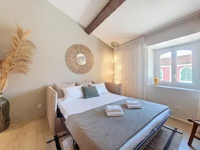 a bedroom with a bed with towels on it at Nestor&Jeeves - BEIGE RIVIERA - Standing suite in Nice