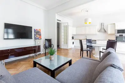 a living room with a couch and a table at Grand appartement climatisé centre ville Nice in Nice