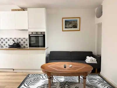 a living room with a couch and a table at Appartement cosy au coeur de la vieille ville in Nice