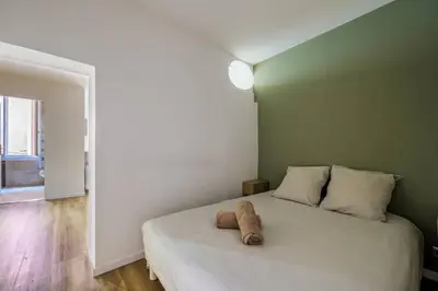 a stuffed animal sitting on a bed in a room at Appartement cosy au coeur de la vieille ville in Nice