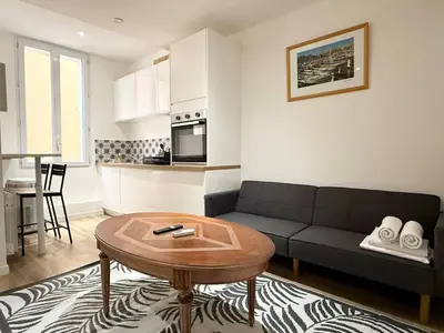 a living room with a couch and a table at Appartement cosy au coeur de la vieille ville in Nice