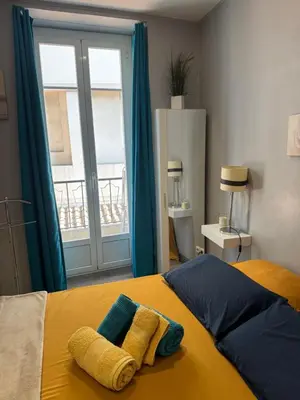 a bedroom with a bed with two towels on it at Agreable 2 pièces Nice liberation in Nice