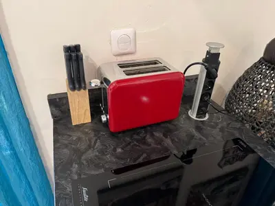 a counter with a toaster and a router on it at Agreable 2 pièces Nice liberation in Nice