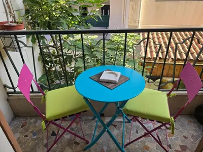 a table and two chairs on a balcony at Agreable 2 pièces Nice liberation in Nice