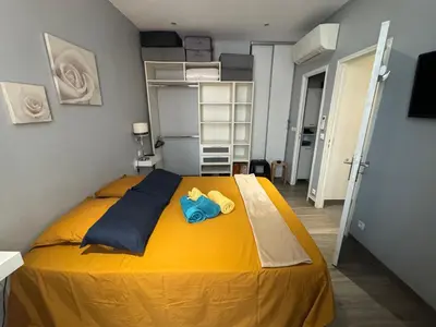 a bedroom with a yellow bed with two stuffed animals on it at Agreable 2 pièces Nice liberation in Nice
