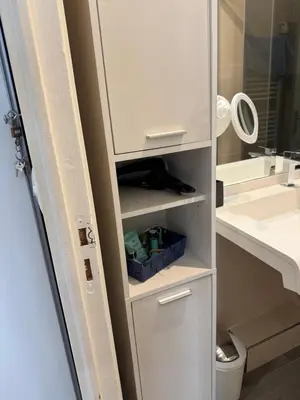 a bathroom with a white cabinet and a sink at Agreable 2 pièces Nice liberation in Nice