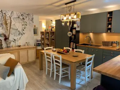 a kitchen and dining room with a table and chairs at L'Échappée Belle in Nice