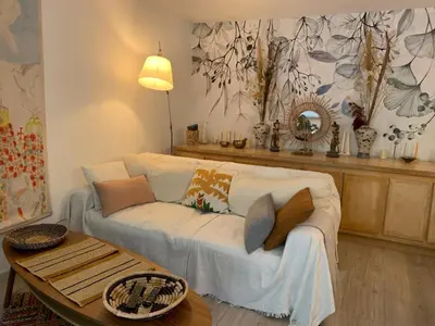 a living room with a white couch and a table at L'Échappée Belle in Nice