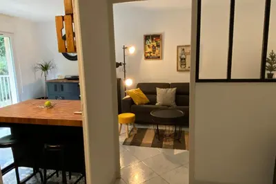 a kitchen and living room with a couch and a table at Beautiful apartment on the heights of Nice - Parking in Nice