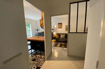 a kitchen and living room with a table in a room at Beautiful apartment on the heights of Nice - Parking in Nice