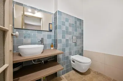 a bathroom with a sink and a toilet at La Quiétude - Spacious - Magnificent mountain view - AC - Jacuzzi in Aspremont