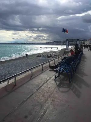 a group of people sitting on a bench on the beach at Bohemian style and luminous balcony in Nice