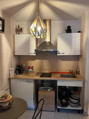 a kitchen with a counter with a sink and a stove at Studio magnan grand balcon in Nice