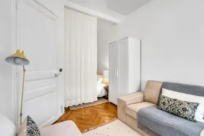a living room with a couch and a chair at Nice design, calme & gare à 5 min à pied in Nice