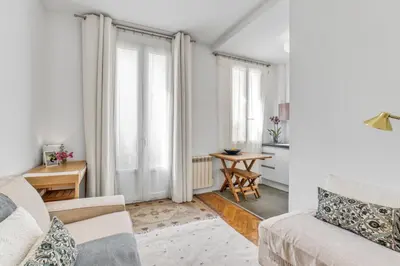 a living room with a couch and a table at Nice design, calme & gare à 5 min à pied in Nice