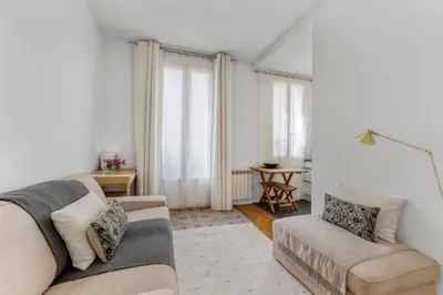 a living room with a couch and a table at Nice design, calme & gare à 5 min à pied in Nice