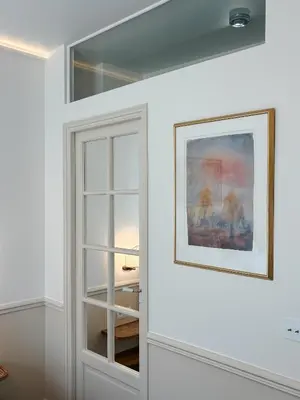 a white cabinet with a glass door in a room at Azur Verdun in Nice