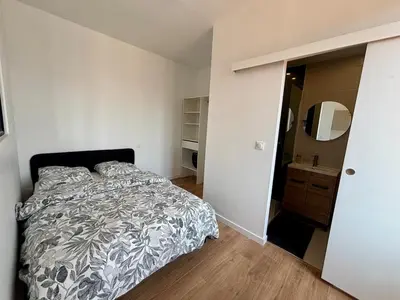 a bedroom with a bed and a bathroom with a mirror at Studio Nice proximité du port in Nice