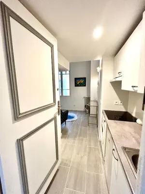 a door leading into a kitchen with a living room at Studio close to Main Street and Train Station in Nice