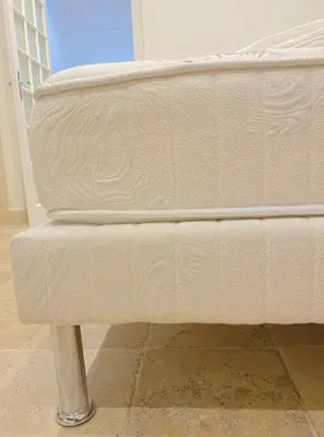 a white bed sitting in a room at Plein centre clim, proche gare et tramway in Nice