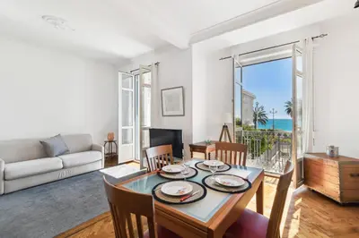 a living room with a table and a couch at HappyFew suite Palazzo in Nice