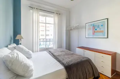 a bedroom with a white bed and a window at HappyFew suite Palazzo in Nice