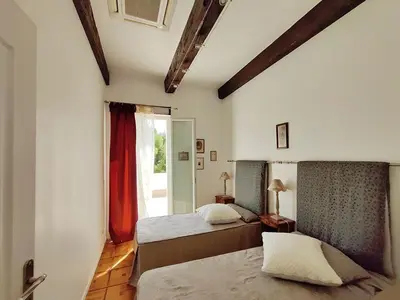 a bedroom with two beds and a window at Magnifique Villa sur les collines de Nice, 6 Pièces, clim, barbecue, sauna et hammam in Nice