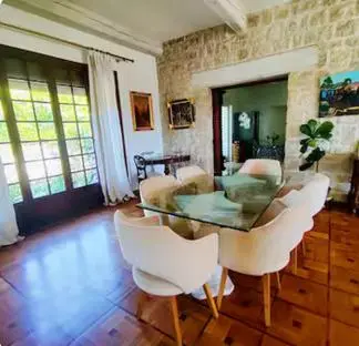 a living room with a glass table and white chairs at Magnifique Villa sur les collines de Nice, 6 Pièces, clim, barbecue, sauna et hammam in Nice