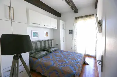 a bedroom with a bed and a lamp and a window at Magnifique Villa sur les collines de Nice, 6 Pièces, clim, barbecue, sauna et hammam in Nice