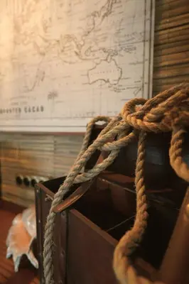 a wooden box with ropes in front of a map at Suite des aventuriers - Expérience Unique & Atypique à Nice proche du centre in Nice