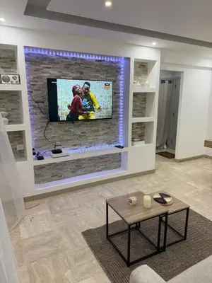 a living room with a flat screen tv on a wall at Appartement Valeria in Saint-Laurent-du-Var