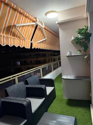 a room with a couch and chairs on a balcony at Appartement Valeria in Saint-Laurent-du-Var