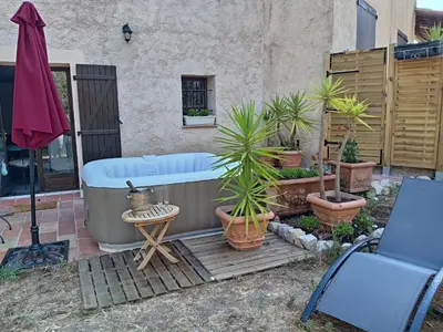 a bath tub with potted plants on a patio at A la campagne aux portes de Nice in Falicon