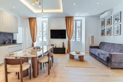 a living room with a couch and a table at Magnifique appartement - Jacuzzi - Port de Nice in Nice